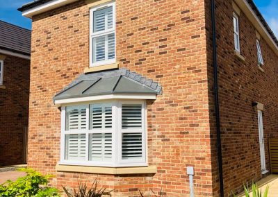 Wooden window shutters supplied and fitted in Newcastle upon Tyne and across the North East by Signature Window Shutters. White Bay window shutters in Northumberland