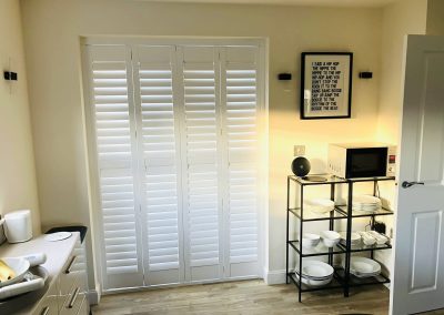 Plantation shutters for windows and doorways supplied and fitted in Newcastle upon Tyne and across the North East by Signature Window Shutters. Bi-fold shutters on a sliding track