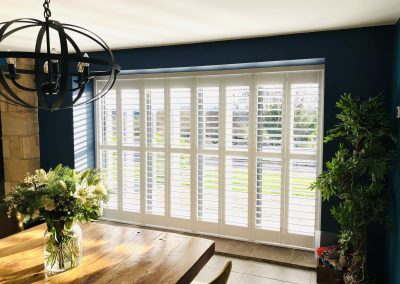 Plantation shutters for dooorways supplied and fitted in Newcastle upon Tyne and across the North East by Signature Window Shutters. Bi-fold shutters on a sliding track