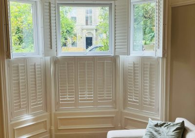 Interior window shutters for bay windows