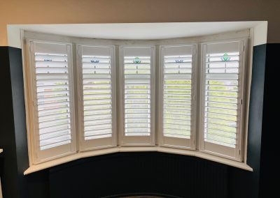 Cafe style bay window shutters, interior plantation shutters