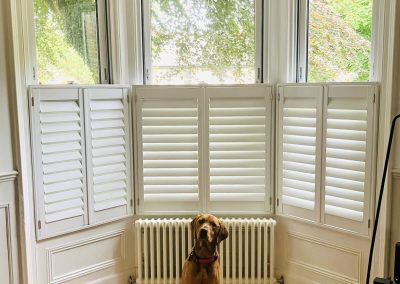 Cafe style white wooden shutters for bay windows. Plantation shutters made to measure in Newcastle