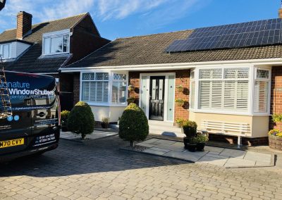 White wooden interior window shutters for bay windows supplied and fitted by Signature Window Shutters in Newcastle and North East England