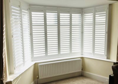 White wooden interior window shutters for bay windows supplied and fitted by Signature Window Shutters Newcastle