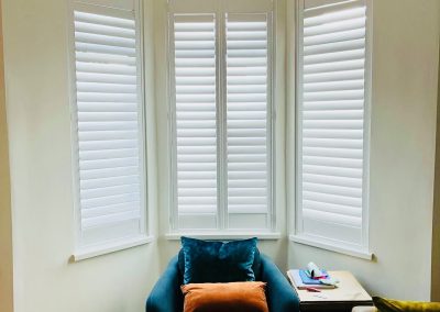 White wooden shutters for bay windows in Heaton, Newcastle upon Tyne. Supplied and fitted by Signature Window Shutters.